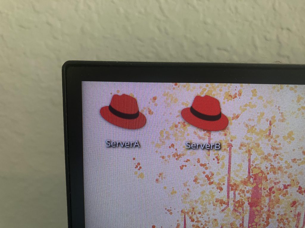 Image of two virtual machines I set up myself, marked as icons, on corner of PC monitor.